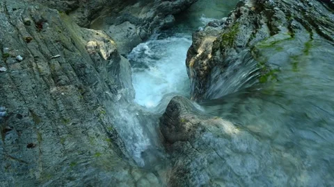 Beautiful waterfall between stones of a rivulet in the mountains Видео 211491651