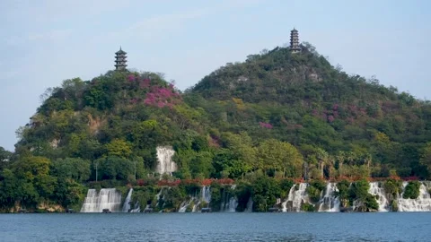 Beautiful waterfall cascading down the hillside on riverbank at Liuzhou, China. Stock Footage 295252362