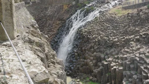 Beautiful waterfall cascading down the unique geological formation of basaltic 스톡 동영상 342041652