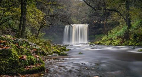 Beautiful waterfall cascading into the riverbed located in south Wales. Stock Photos