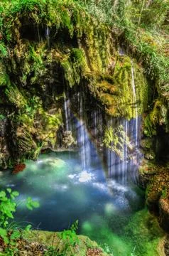 Beautiful waterfall deep into the forest. Stock Photos
