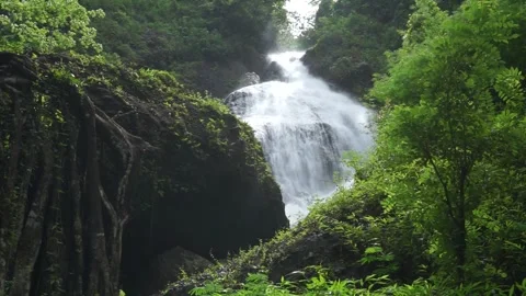 A beautiful waterfall during the day Видео 296735130