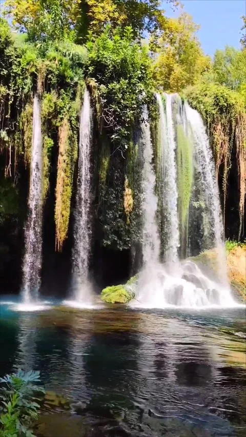 A beautiful waterfall falling from a cliff in  picturesque forest place Stock Footage 289841270