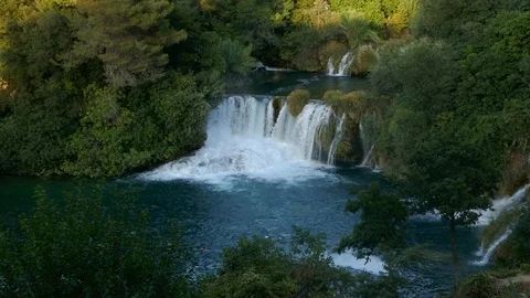Beautiful waterfall falling in a pond shaping a river Stock Footage 90268036