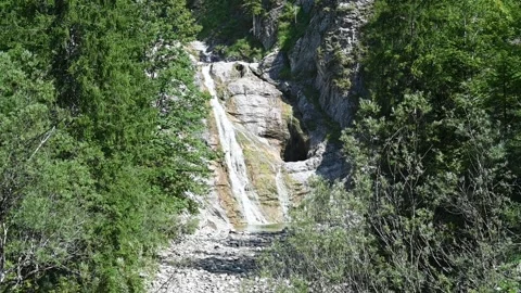 A beautiful waterfall flowing down rocks in summer (slow motion) Stock-Footage 219631476