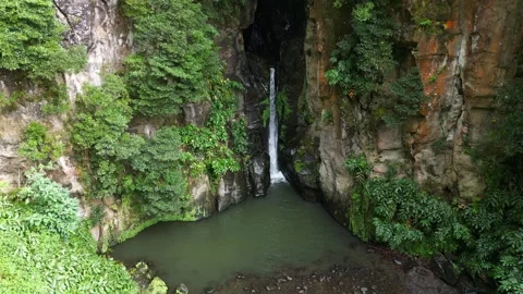 A beautiful waterfall flows over smooth rocks in a lush forest. Stock Footage 321079401