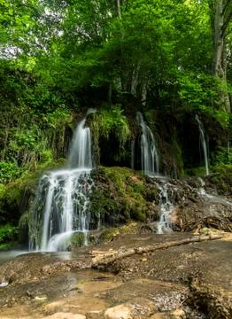 Beautiful waterfall in the forest in spring Stock-Fotos