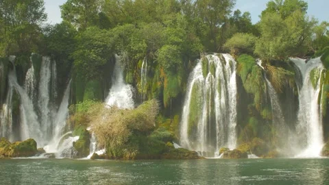 Beautiful waterfall Kravica surrounded by forest flowing into a river, in Bosnia Stock Footage 241600645