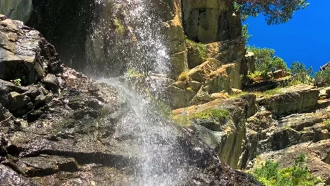 A beautiful waterfall on mountain rocks in the Caucasus gorge Vidéo 160858293
