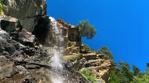 A beautiful waterfall on mountain rocks in the Caucasus gorge Stock Footage 160858327