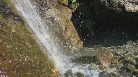 A beautiful waterfall on mountain rocks in the Caucasus gorge Stock Footage 160858735