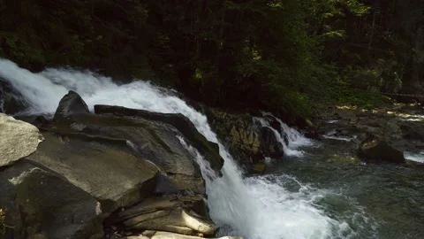 Beautiful waterfall in the mountains between the trees Video stock 143866614