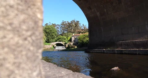 Beautiful waterfall under old stone bridge in rural Portugal Stock Footage 157869598