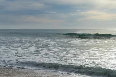 Beautiful waves and clouds over the sea Stock Photos