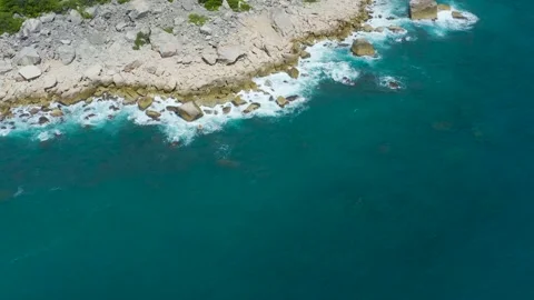 Beautiful waves dissolve into rocks on a Caribbean beach. Blue sea water. Stock Footage 161032743