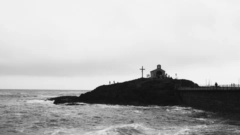 Beautiful waves hit the rocks. Cloudy weather. Swaying sea. Romantic view of the Stock Footage 121613884
