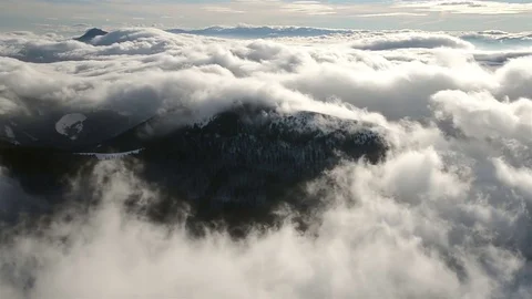 Beautiful waves of low clouds flows in winter mountains time lapse Stock Footage 70216338