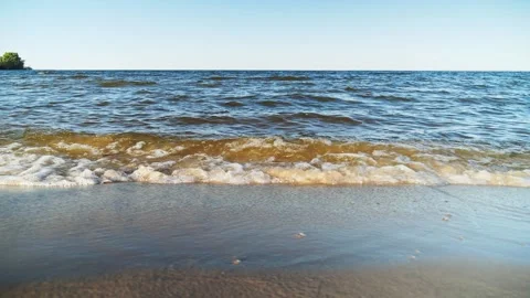 Beautiful waves roll over the river beach. Close up shot 스톡 동영상 250155633