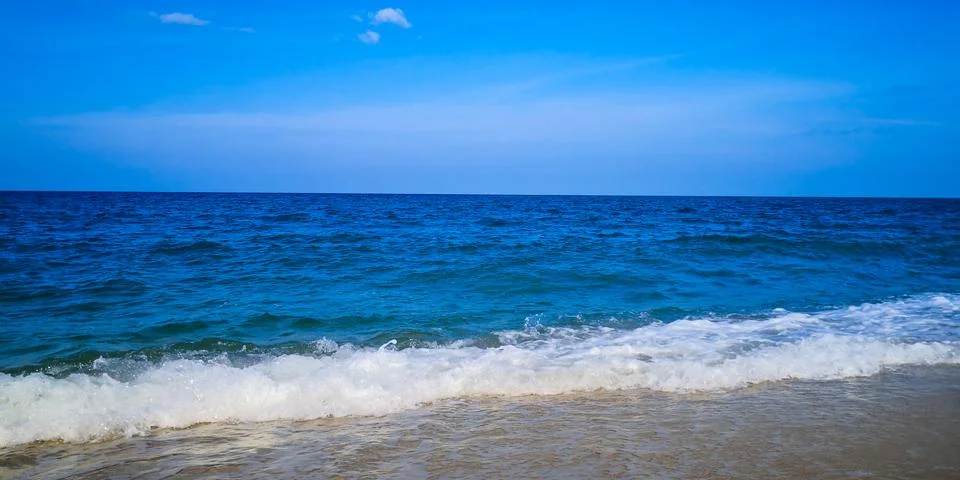 Beautiful waves at a sandy beach Stock Photos