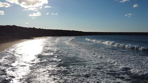 Beautiful waves  wash the sandy shore at sunset day. Panorama from above, Cyprus Stock Footage 124649256