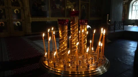 Beautiful Wax Candles flame inside of old traditional Russian Orthodox Church Stock Footage 140823337