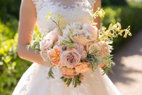 Beautiful wedding bouquet in bride's hands. Stock Photos