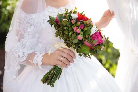 Beautiful wedding bouquet in hands of the bride Stock Photos