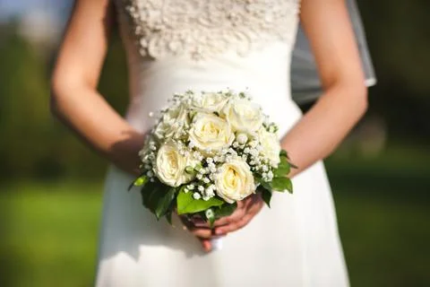 Beautiful wedding bouquet in hands of the bride Stock Photos