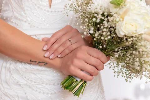 Beautiful wedding bouquet in hands of the bride. Stock Photos