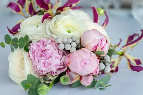 Beautiful wedding bouquet with white and pink roses is on the table Stock Photos