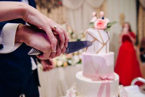 Beautiful wedding cake bride and groom cut into pieces Stock Photos
