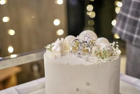 Beautiful wedding cake with elements of wedding rings. Wedding celebration. Stock Photos