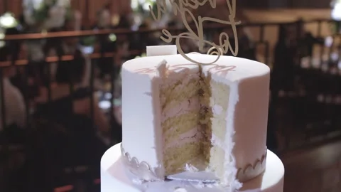 Beautiful wedding cake with the first slice cut by the couple. Stock Footage 166012870