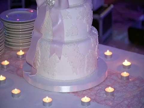 Beautiful wedding cake stands on the table with candles Stock-Footage 80502293