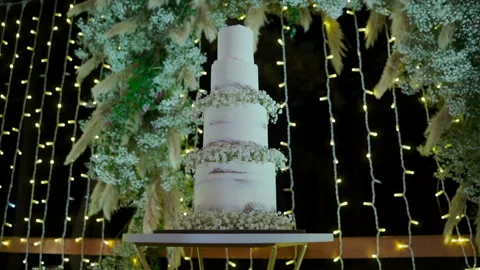 Beautiful wedding cake on table decorated with lights Stock-Footage 149600457