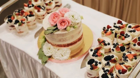 Beautiful wedding cake on the table. Very beautiful and delicious food Stock Footage 124700761
