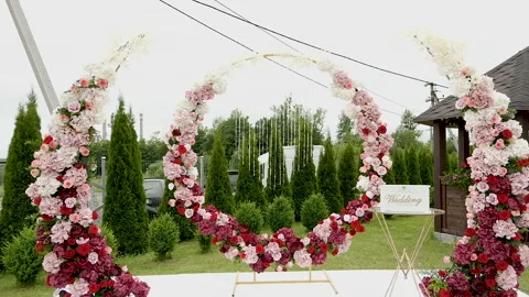 Beautiful wedding decor with red-pink flowers on the street Stock Footage 139280907