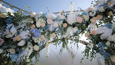Beautiful Wedding decor. Wedding arch with fresh flowers on summer sunny wedding Stock Footage 196003456