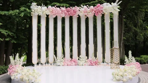 Beautiful Wedding decor. Wedding arch with fresh flowers on summer sunny wedding Stock Footage 196005279