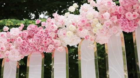 Beautiful Wedding decor. Wedding arch with fresh flowers on summer sunny wedding Stock Footage 196005336