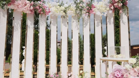 Beautiful Wedding decor. Wedding arch with fresh flowers on summer sunny wedding Stock Footage 196006374