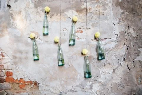 Beautiful wedding hand made rustic decorations of glass bottles and flowers. Stock Photos