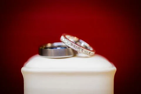 Beautiful wedding ring set on a white box and red background. Stock Photos