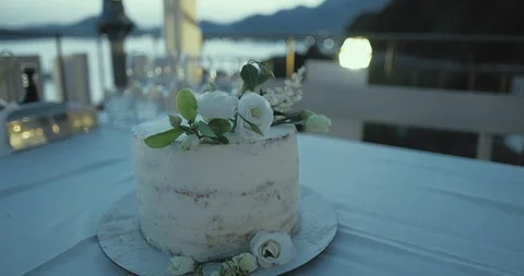 Beautiful wedding Rustic cake displayed on table in the background. Stock Footage 112885690