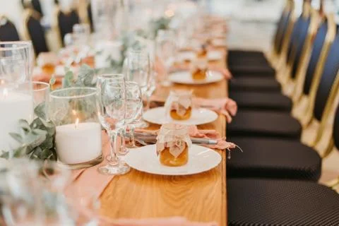 Beautiful wedding table setting decorated with flowers and candles Stock Photos