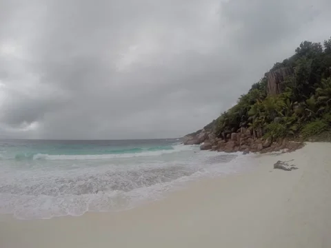 Beautiful white beach on a cloudy day. Seychelles, Praslin. Stock Footage 131337062