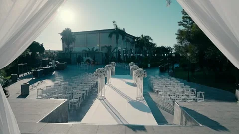 A beautiful white canopy and sets for guests are prepared for a wedding day. Stock Footage 249107505