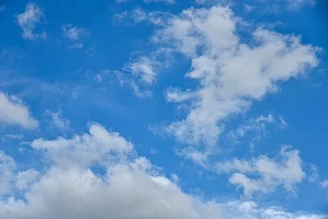 Beautiful white clouds on blue sky background. Stock Photos