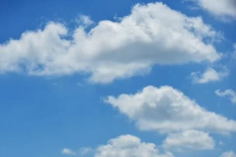 Beautiful white clouds on blue sky background. Stock Photos