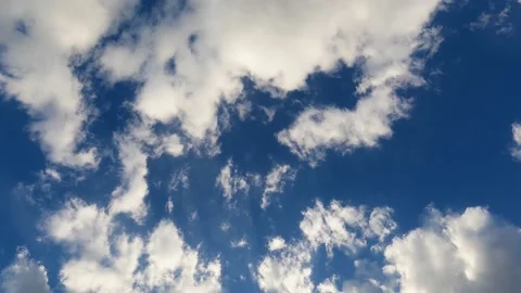 Beautiful white clouds on a bright blue sky. Time lapse. Stock Footage 238526994
